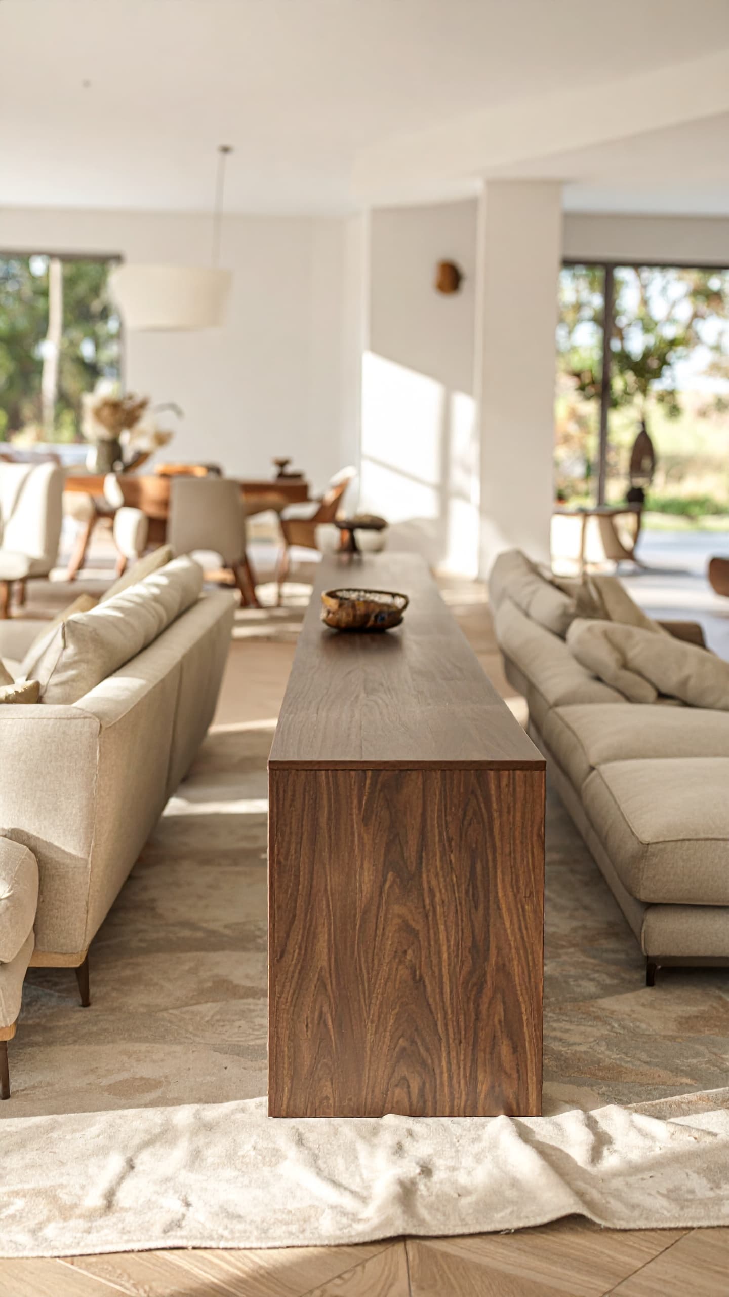 Stylish console table functioning as low room divider with decorative items